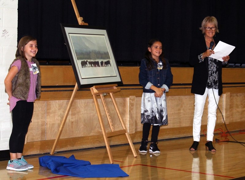 Students Madelyn Cruickshank, left, and Brynn Hill, centre,who both worked on the Robert Bateman mural last year when they were in Grade 3, with art teacher Ruth Handford.