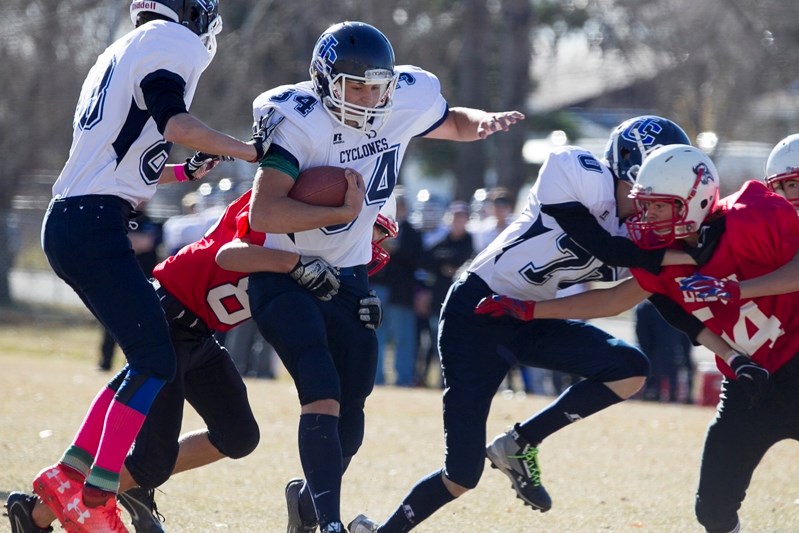 Innisfail Cyclones&#8217; Sam Cuff tries to shed a tackle from a Sundre Bison player during the team&#8217;s semifinal game at Innisfail High School on Oct. 21.