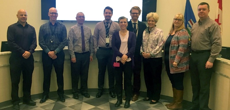 Town staff wore purple to help raise awareness about family violence prevention month on Nov. 1. Left to right: Coun. Glen Carritt; CAO Todd Becker; Henry Wong, director of