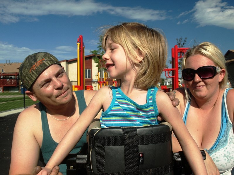 Brooke Aubuchon with her dad Darcy and mother Robin Brand during a past summer time outing.