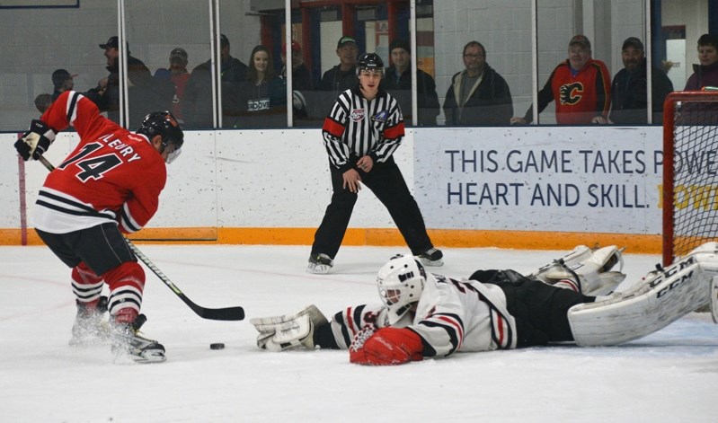 Former NHL superstar Theoren Fleury undresses Eagles netminder Jake Mullen before scoring his first of four goals in Saturday&#8217;s NHL alumni game at the Innisfail Arena.