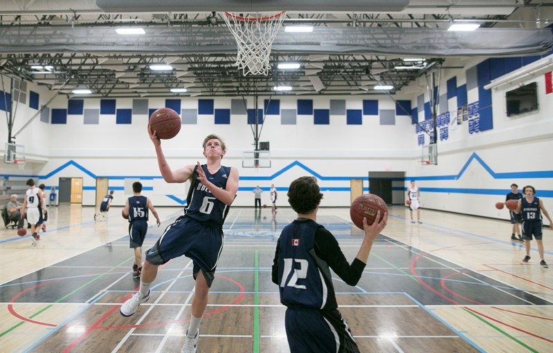 Tanner Woodruff attempts a crossover layup during a drill.