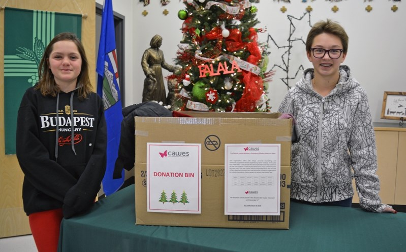 Grade 8 students at St. Marguerite Bourgeoys, Jayda Telford, left, and Brooke Stout, turned a class project into reality and raised funds and collected items for the Central