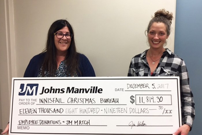 Cathy Ouellette, human resources manager at Johns Manville, left, presents a cheque for more than $11,000 to Karina Lucas of the Innisfail and District Christmas Bureau.