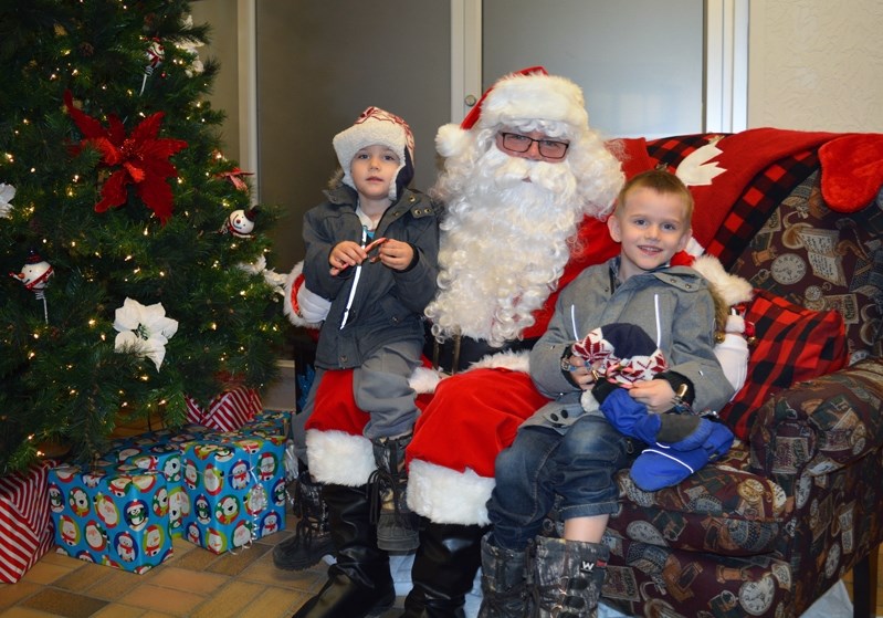 Brothers Braxton, left, and Ronan Hubschmid were two of several children to visit Santa Claus at the Co-op Mall on Saturday (Dec. 9). The visit was part of a coordinated