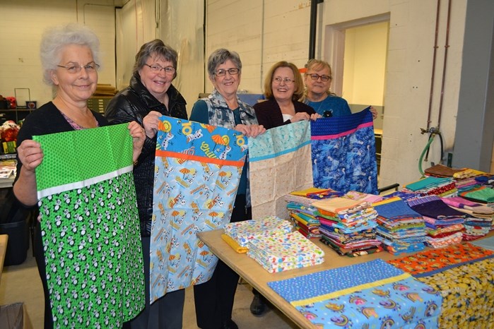 Members of the Wild Rows Country Quilters Guild at the Christmas Bureau on Nov. 24 with their recently made pillowcases. From left to right is Pat Layden, Tillie Becker, Lola 