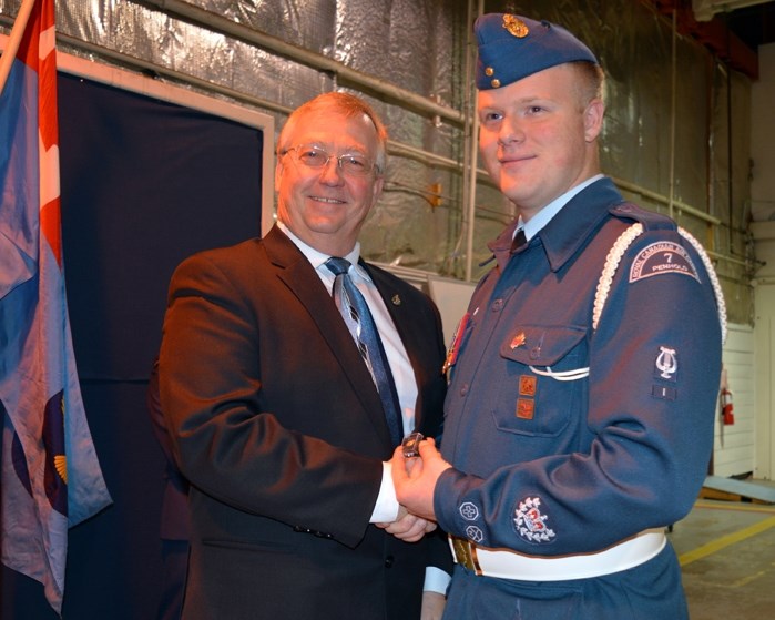 Warrant Officer Class 2 Jarrod Crashley right, with the 7 Penhold Air Cadets, received his Gold Duke of Edinburgh award pin from MP Earl Dreeshen during a Nov. 18 ceremony in 