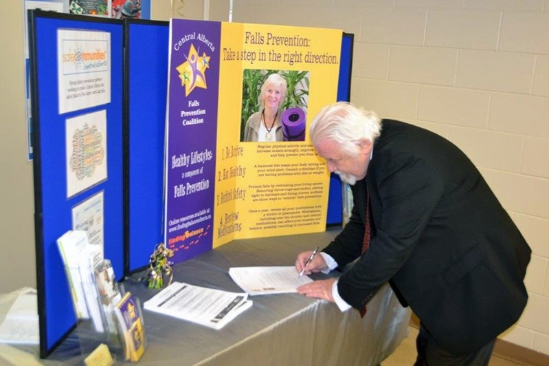 Penhold mayor Dennis Cooper signs the 2016 Falls Prevention Month proclamation in Penhold on Nov. 9 at the Penhold Regional Multiplex.