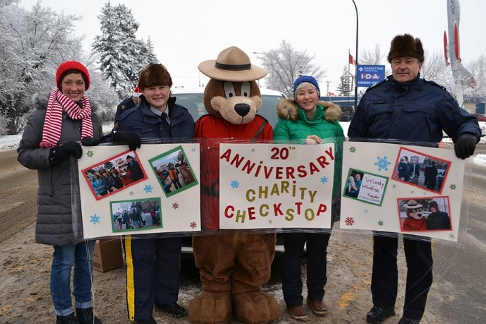 Organizers for the 20th annual Charity Check Stop in Innisfail proudly gather on Main Street on Dec. 12. From left to right is Karina Lucas, vice-chair of the local Christmas 