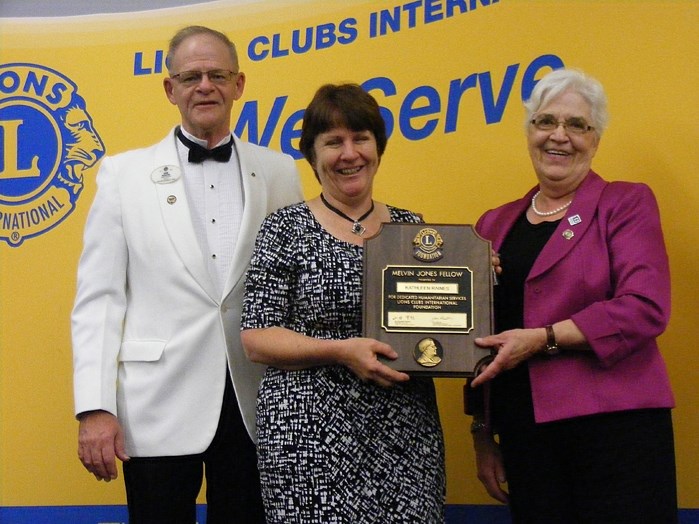 Kathleen Raines (centre) being presented with her Melvin Jones Fellowship Award. At left is District Governor Hank Hoekstra, and at right is past District Governor Donna