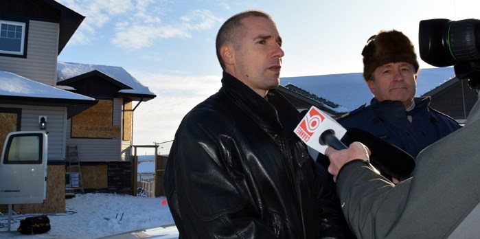 Mike Letourneau, left, with the Safer Communities and Neighbourhoods (SCAN) and Alberta Law Enforecment Response Teams (ALERT), speaks to media during a press conference in