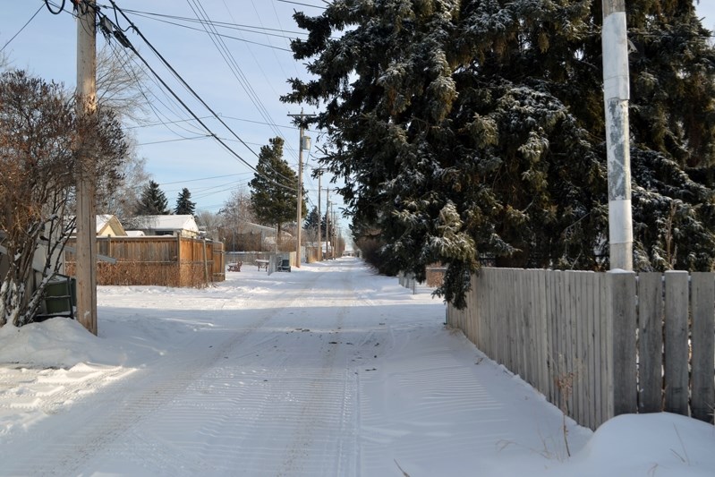 A residential alley in Innisfail where a large tree is growing over the property line and above the lane. Town council was on Jan. 8 told it was not uncommon for town staff