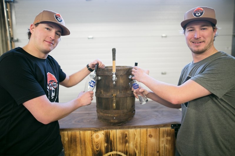 Brothers Nick, left, and Scott Bell with a custom beer tap in Innisfail on Jan. 11.