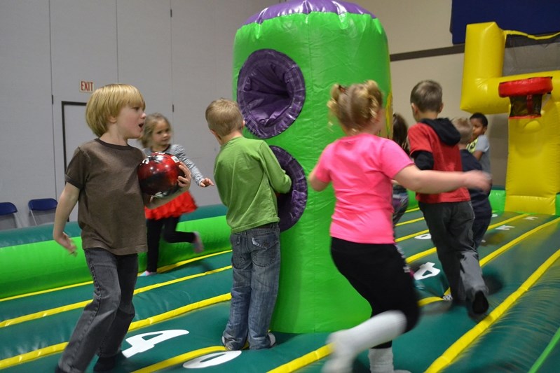 Children race on top of one of the two bouncy castles featured at the inaugural Penhold Winter Carnival.