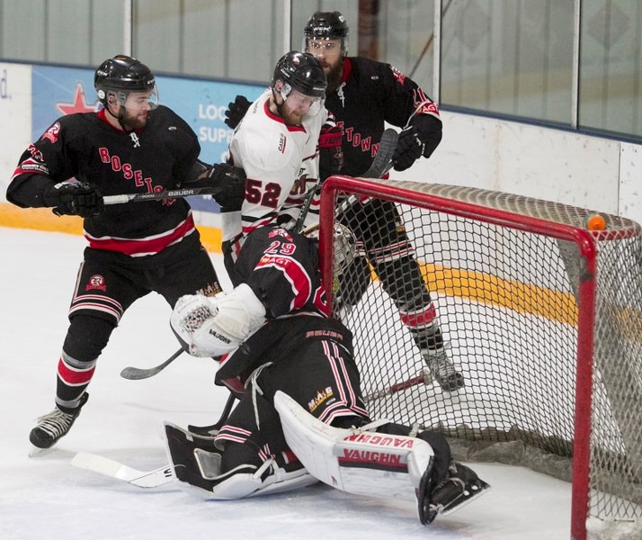 Innisfail Eagle Sam Lawson puts pressure on in front of the Red Wings net during weekend action at the Innisfail Arena. The Eagles lost both home games.