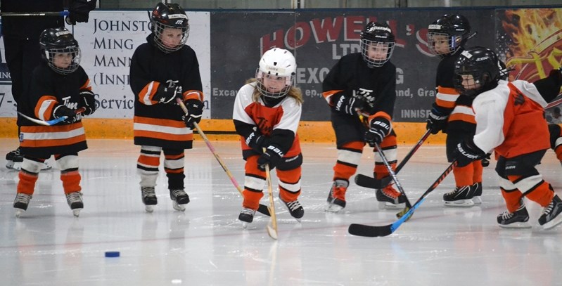 A group of Eaglettes eye the puck and are ready to begin the chase.