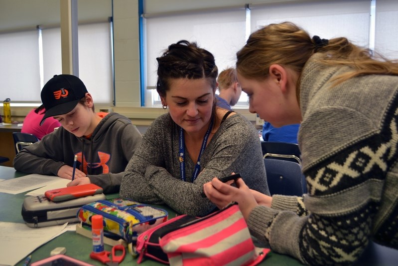 Grade 8 teacher Amanda Oslund, centre, said students were eager to learn about the newspaper industry as part of a three-week class project.