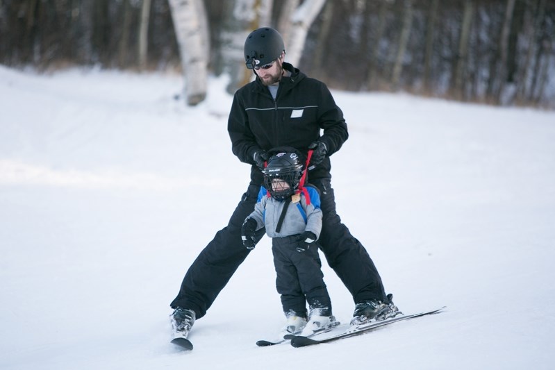 Tyler Hunter helps Brody Hunter ski down one of the runs at the Innisfail Ski Hill.