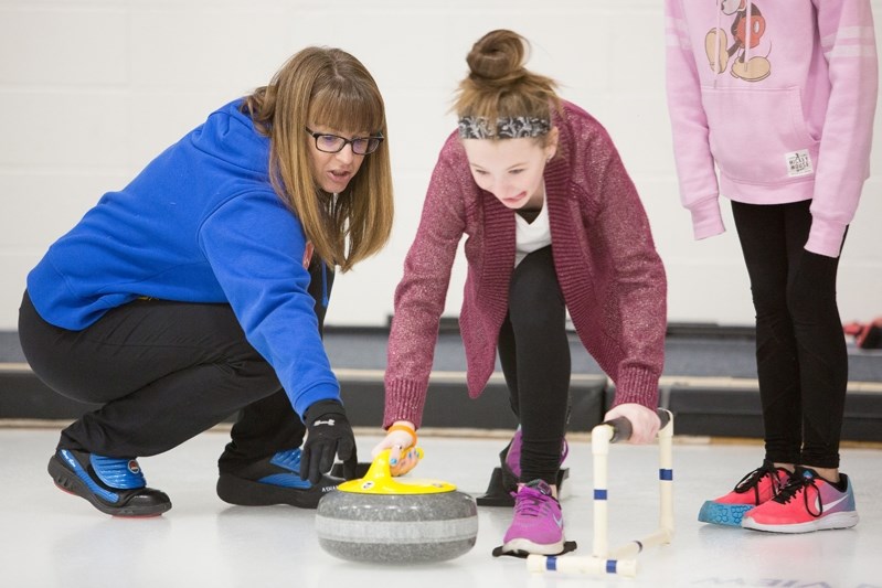 Heather Nedohin works with Sarah Hoppins during the session.