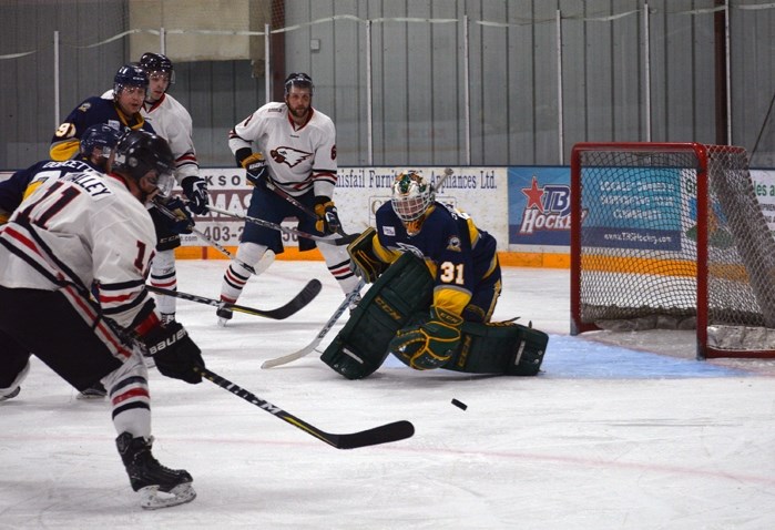 Innisfail Eagles forward Brett O&#8217;Malley lines up a shot against the Stony Plain Eagles during Game 4 of the semifinals of the Allan Cup Hockey West playoffs at the