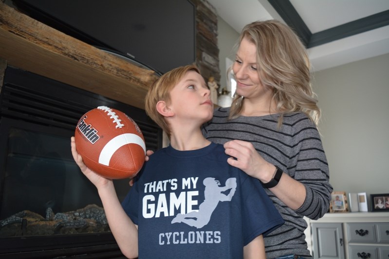 Luka Ellis and mom Alexis Verhegge desperately hope Innisfail minor football can be saved from folding.