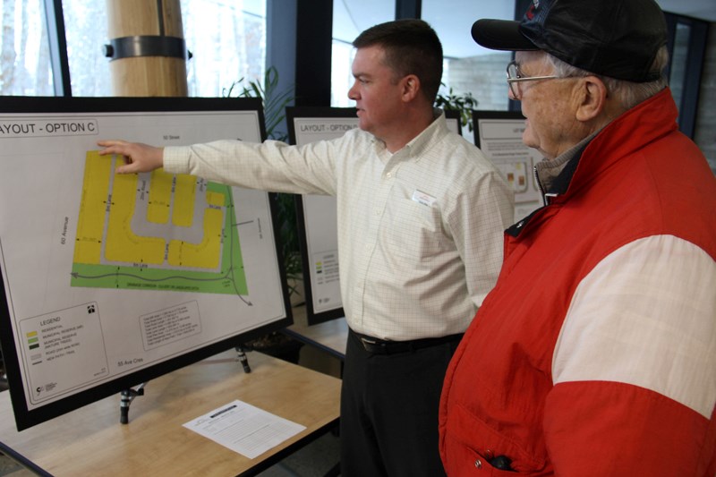 Director of planning and development Craig Teal discusses options for the development of a new subdivision in the Napoleon Lake area with a resident during an open house on