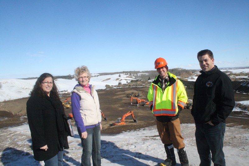 (L-R) Rupertsland Institute representatives Lorna Lang and Gerrie Barros stand above the work pit alongside student Trenton Plaizier and Interior Heavy Equipment Operator