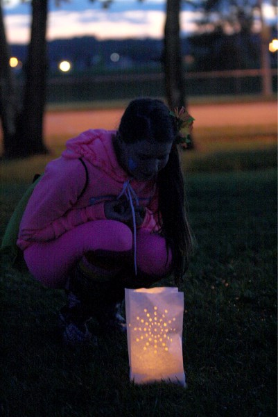 Jada Styner considering a luminary at the Innisfail Jr./Sr. High School football field lit as part of the Relay for Life walk June 7.