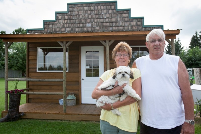 Lynn and Ken McCarthy at the miniature saloon they built in their yard. Ken said in spite of the town&#8217;s objections the structure is going to stay.