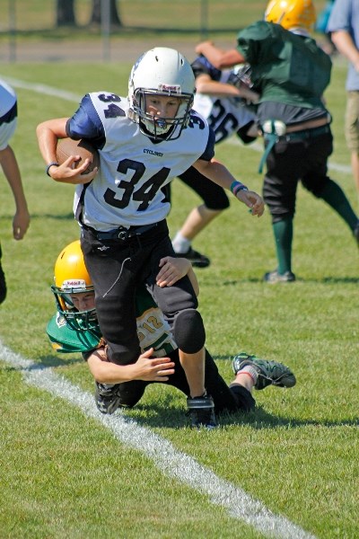 PeeWee Nathan Fuerbringer getting tackled by Rocky Jr. Rebel in the IMFA&#8217;s True Grit Exhibition Event.