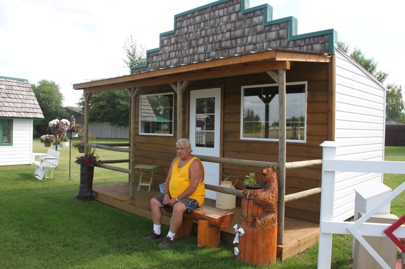 Ken McCarthy sits by his handmade saloon.