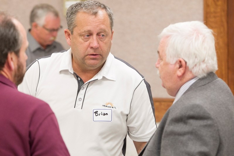 Innisfail Mayor Brian Spiller chats with Penhold Mayor Dennis Cooper at an elected councillors&#8217; orientation meeting in Olds shortly after the Oct. 21 election.