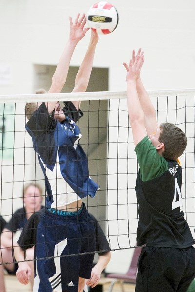 Innisfail Cyclones player Colten Webster attempts to block a shot from a West Central High School Rebels player during their game at Innisfail High School on Oct. 30.