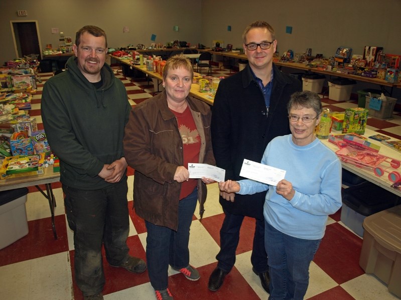 Staff at NWP Industries Inc. hand over two cheques totalling $3,600 to the Christmas Bureau on Dec. 6. From left to right: Jon Goorts, pipefitter; Peggy Gallais, accounts