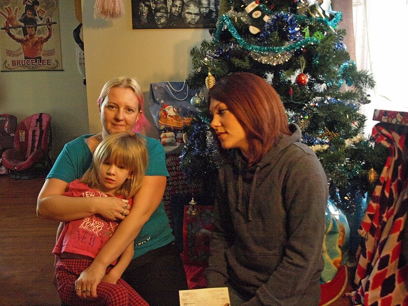 Kristen Spatz, night manager at the Fox and Hound, gives Robin Brand (left) a cheque for $2,500 that was raised at the club&#8217;s annual Christmas fundraiser to help the