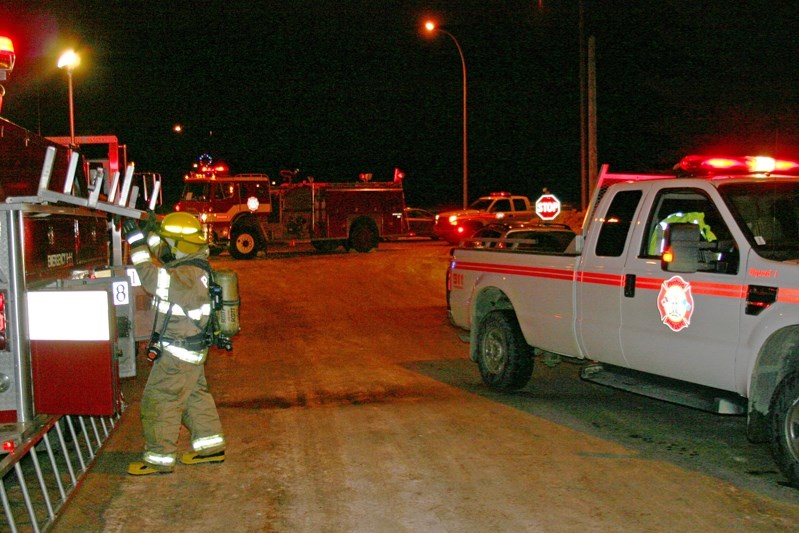 Firefighter looks for equipment during chimney fire in Penhold on Dec. 17.