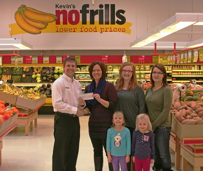 Kevin Meyer, of Kevin&#8217;s nofrills, donates $1,550 from the sale of Christmas trees to phase one of the playground enhancement project at John Wilson/St. Marguerite