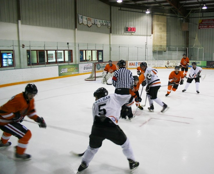 The Elfs and Reindeer battle for the puck at the third annual Christmas Classic hockey game on Dec. 23. The game raised $400 and 200 lbs. of food for the Innisfail and Area