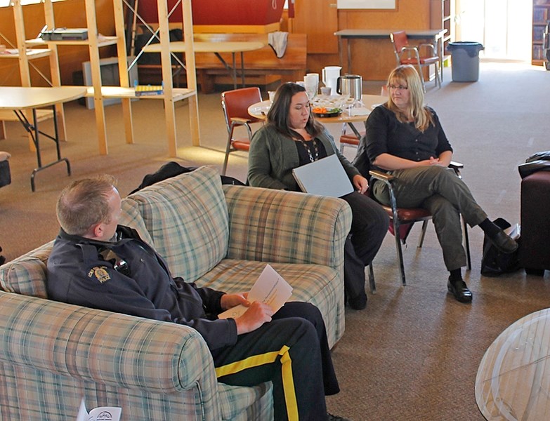 nnisfail RCMP Const. Chris Lavery (left) listens to Christie Carlson, youth services supervisor and Alissa McDonald, parents support of the Sylvan Lake Family Violence and