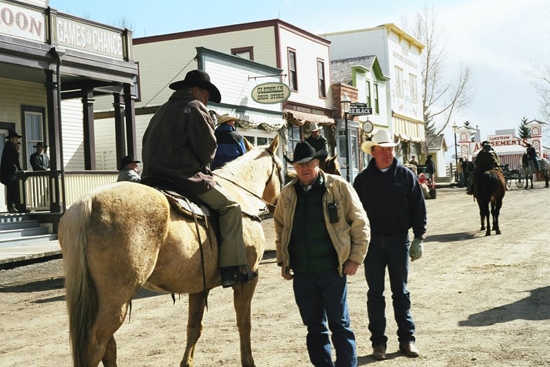 John Scott (middle) on set of The Legend of Butch and Sundace at a transformed Heritage Park street directing stunt men before a scene.