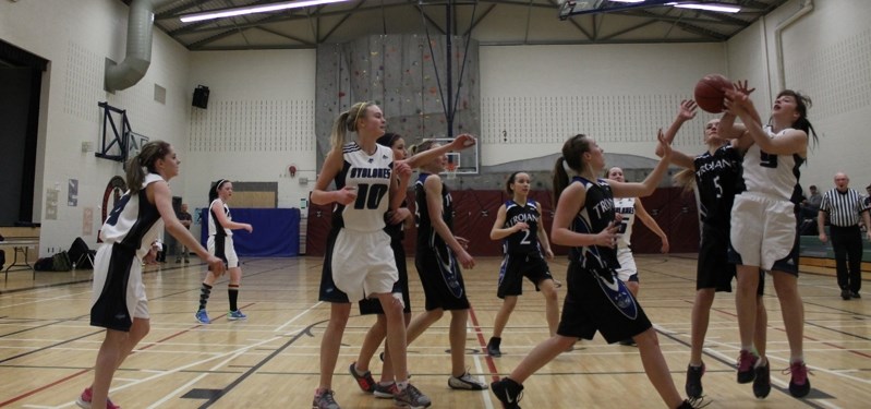 Brea Bryant (far left) and Emily McCook look on Daniella Nagy and a Delburne Trojan battle for the basketball at the March 4 Gold Medal Chinooks Edge North Athletic