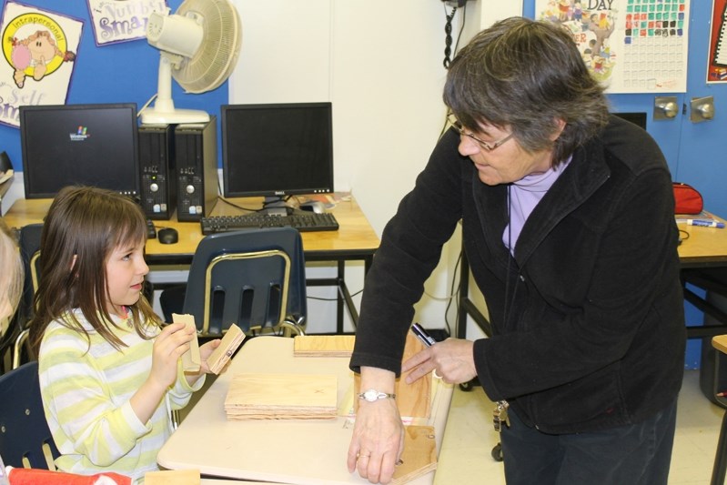 Ecole John Wilson Grade 3 student Serena Ingram asks teacher Corinne Jewel advice on putting her birdhouse together during Mulitple Inteliigence Day on April 3.