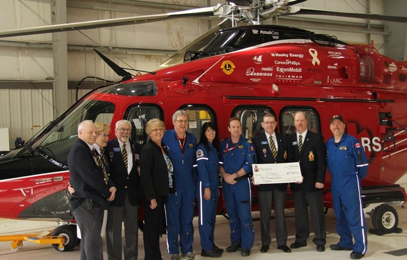 Standing in front of the new STARS helicopter, an Augusta Westland 139, are from left to right;Jim Rich, past president; Gail Tetzlaff, ladies auxiliary president; Pat