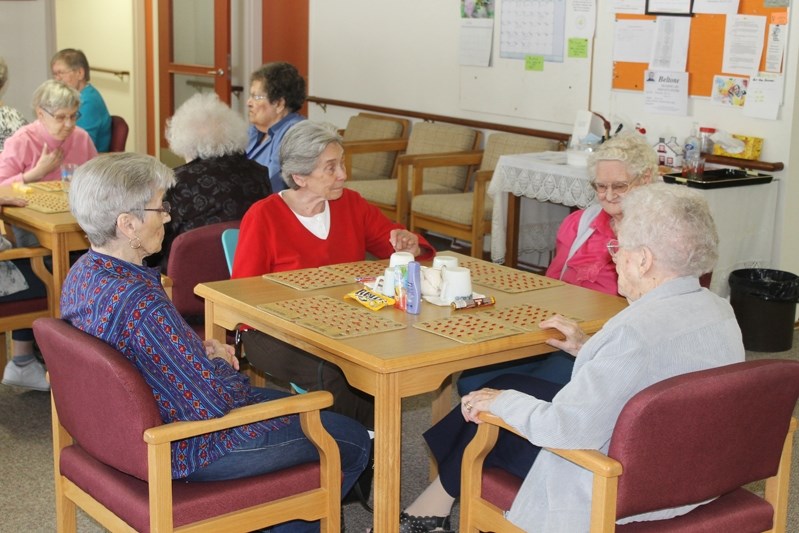 Cecilie Wilcox (far left), Anna Marie Montezuma, Annie Murphy and Isabel Carter (far right) play bingo at Autumn Glen Lodge during a recent afternoon.