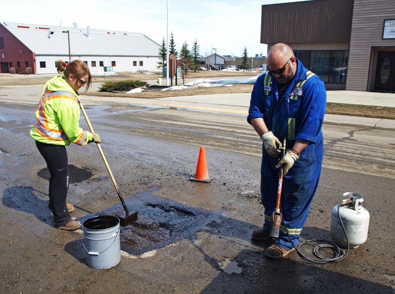 Town public works employees Kalie Jacobsen and Brad Wilson were busy repairing potholes on 45 Avenue this month.