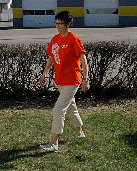 Charlene Carver, committee chair of the Canadian Cancer Society Relay For Life, practises walking for the June 20 event to be held at the Innisfail Jr/Sr High school football 