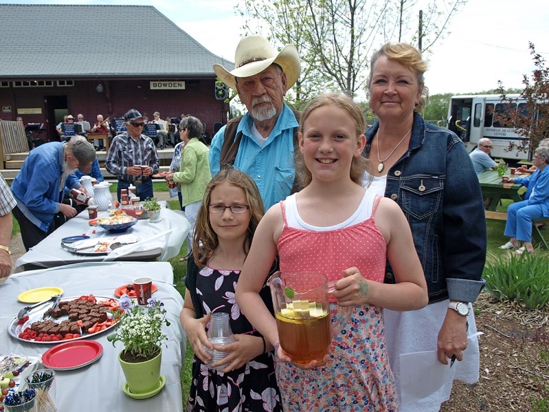 Grandparents and grandchildren enjoy the senior tea held at the Innisfail Historical Village.