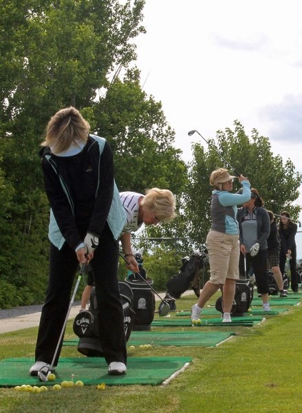 Ladies practise to improve their tempo, tension, and balance in their swings at the driving range at the Innisfail Golf Club on June 18.