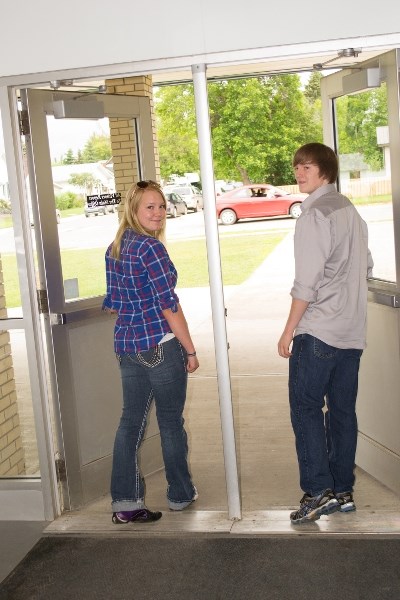 Courtney Orton and Shawn Abraham, co-valedictorians of 2014 Innisfail Sr High School class leave school for one of their last times.