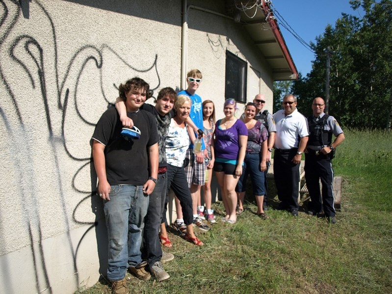 Young volunteers gather with FCSS officials, community peace officers and Mayor Brian Spiller to start the clean up of graffiti on the buildings at the Innisfail Ski Hill on